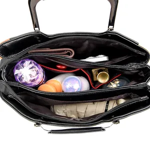 Spacious black leather handbag interior with multiple compartments for easy organization