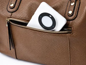 Detail view of the back zipper pocket on a brown lychee grain leather Boston bag for phone storage