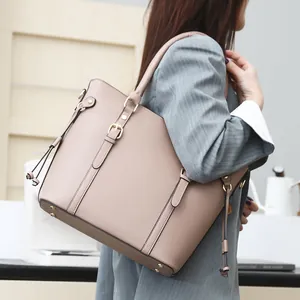 Large soft leather tote bag in nude pink with gold buckles and side tie details