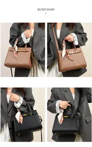 Detail of classic pebbled leather handbags with gold hardware and silk scarf handles