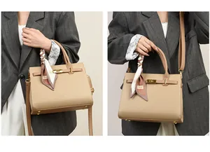 Detailed view of khaki leather tote with gold hardware and silk scarf on top handle