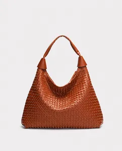 Detail of brown woven hobo bag showing the intricate premium faux leather texture