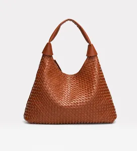 Close-up of caramel woven leather hobo bag showing high-quality intrecciato craftsmanship