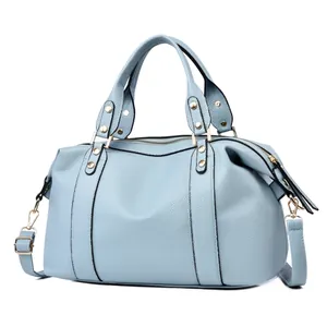 Macro detail of light blue lychee pattern leather and gold metal hardware on Boston bag