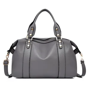 Detail view of dark grey lychee pattern leather Boston bag with gold rivets and hardware