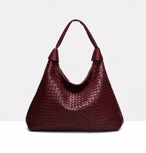 Macro detail of the premium burgundy woven leather texture on this large hobo shoulder bag