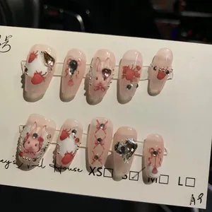Handmade pink Alice in Wonderland press-on nails with 3D bunny and strawberry charms