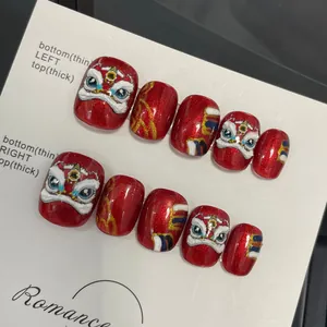 Handmade red glitter press-on nails with 3D lion dance relief and festive design