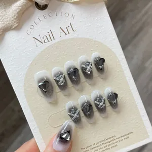 Black and white gradient press-on nails with heart gems and silver chain accents