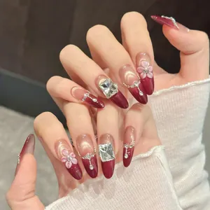 Faux ongles amande dégradés rouge effet œil de chat, fleurs 3D et strass luxueux brillants