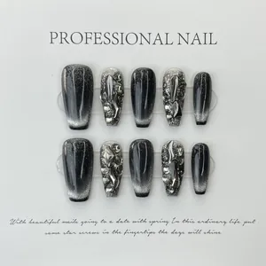 Handmade black cat-eye press-on nails with rhinestone accents and silver glitter finish