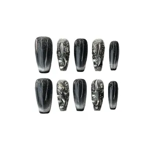 Handmade black cat-eye press-on nails with silver glitter and metallic rhinestones