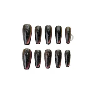 Cat eye press-on nails in long coffin shape with deep purple galaxy glitter effect