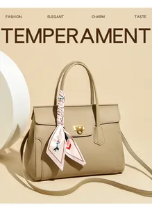Detail of khaki tote bag featuring lychee texture, gold twist lock and printed silk scarf