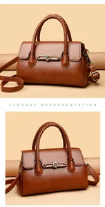 Macro view of caramel leather handbag with braided handles and golden kangaroo metal clasp