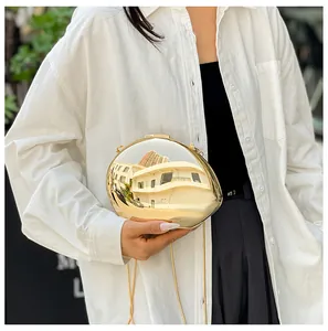 Polished gold pebble-shaped clutch bag with metallic mirror finish and thin chain