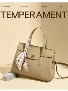 Detail of beige lychee leather tote bag with gold Gancini lock and geometric silk scarf