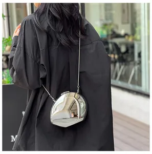 Modern silver mirror egg-shaped crossbody bag with liquid metal texture and sleek chain