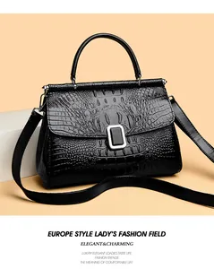 Close-up of black crocodile texture handbag with silver metal buckle and handle