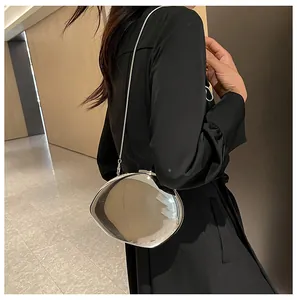 Detail of silver mirror acrylic shell evening bag with slim metallic chain strap