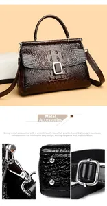 Detail of silver buckles and crocodile texture on this dark brown leather bucket bag