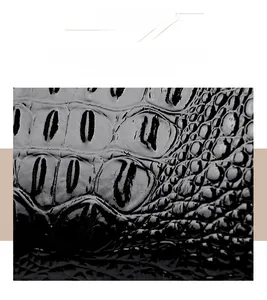 Macro detail of wear-resistant black crocodile embossed leather with glossy texture