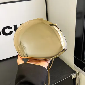 Golden acrylic egg-shaped clutch bag with luxury metallic mirror finish and chain