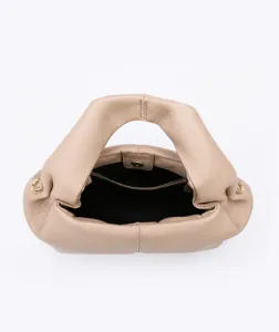 Top view of beige cloud bag showing internal zipper pocket and main compartment