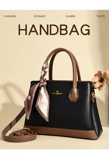 Close-up of lychee grain leather handbag with silk scarf wrap and gold kangaroo logo