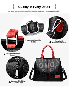 Detail view of black lychee leather handbag with red trim and silver metal hardware