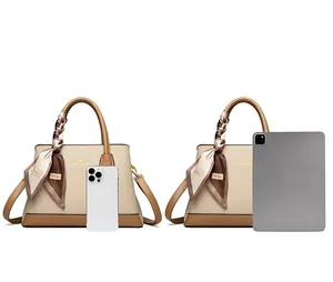 Contrast view of large leather handbag with iPhone and iPad to show size and capacity