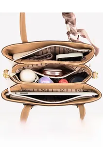 Top view showing large capacity three-compartment interior of the khaki tote handbag