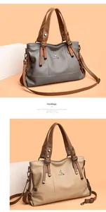 Close-up of litchi grain leather handbags in blue and beige with brown top handles