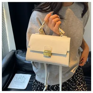 Chic cream faux leather handbag with gold clasp and shoulder strap for women