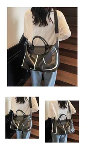 Black travel tote bag with white LGP letters and leather handles on stairs