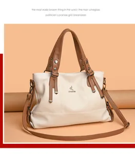 Detail of white lychee grain leather tote bag with brown straps and ZMBIRD bird logo