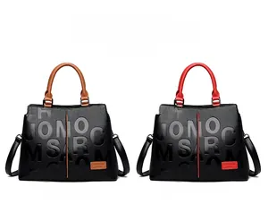 Detail view of large capacity pebbled leather tote bags with embossed patterns and top handles