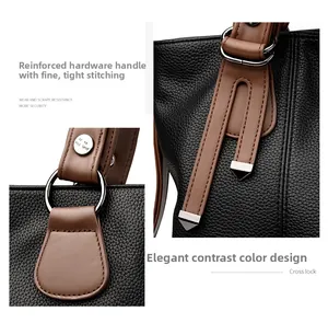Close-up of litchi texture leather, silver hardware, and reinforced stitching on tote bag