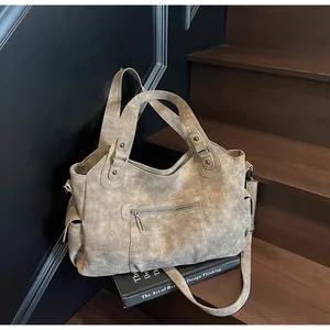 Macro view of retro matte tote bag with washed leather texture and metal rivets