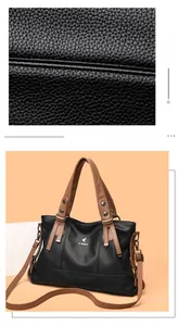 Detailed view of stitching and dual-tone lychee grain texture on crossbody handbag