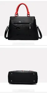 Rear and bottom view of a textured black leather tote with red accents and metal feet