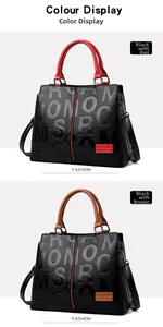 Close-up of litchi texture leather handbags with letter embossing in red and brown handles