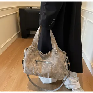 Model showing large vintage matte leather tote bag with functional pockets for daily use