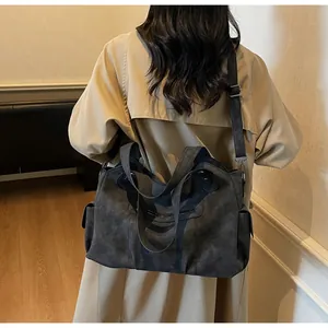 Detailed view of grey frosted tote bag with adjustable shoulder strap and side pocket