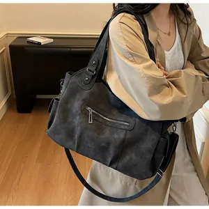Detail view of large matte tote bag with side pockets and detachable strap
