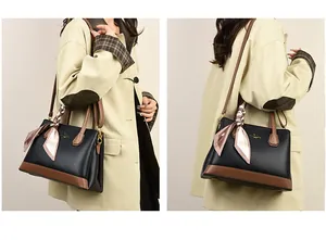 Detail of black lychee grain leather tote with brown base and silk scarf accessory