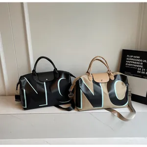 Detail showing high capacity travel bags with leather handles and NC lettering