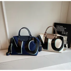 Detail of large travel bags with leather handles and NONO letter print for fitness and travel