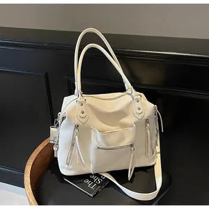 Dettaglio della borsa tote in pelle martellata bianco crema con tasche a zip
