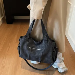 Retro charcoal grey matte tote bag with rivet details and spacious multi-pocket design